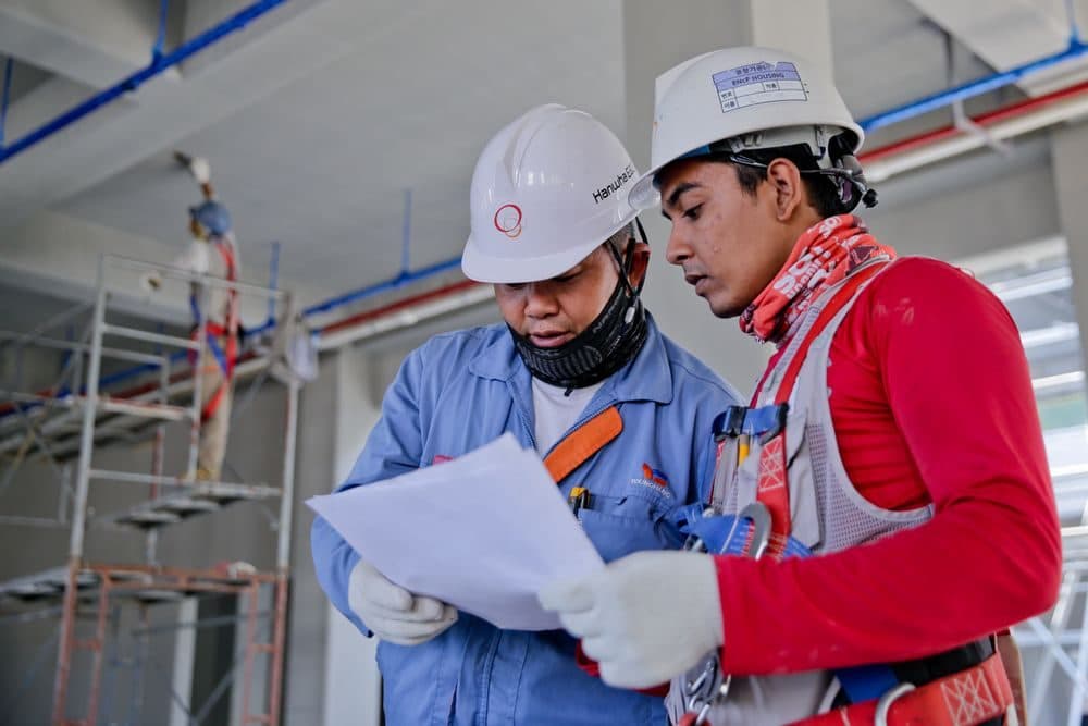 Construction workers wearing helmets and protective workwear